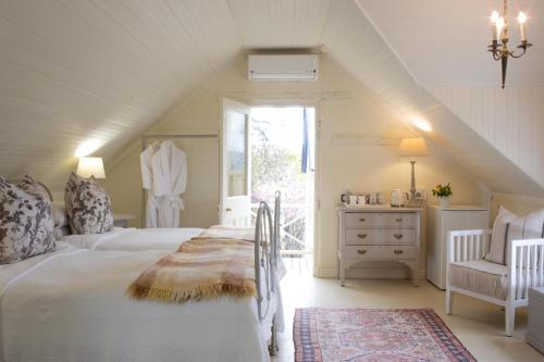 a bedroom with a large white bed and a window at Prince Albert Country Stay in Prince Albert
