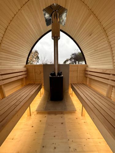 a room with two benches and a light pole at Esterra Vini Guest House in Perushtitsa