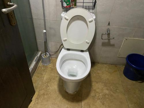 a bathroom with a white toilet in a stall at Luxurious B in Lagos