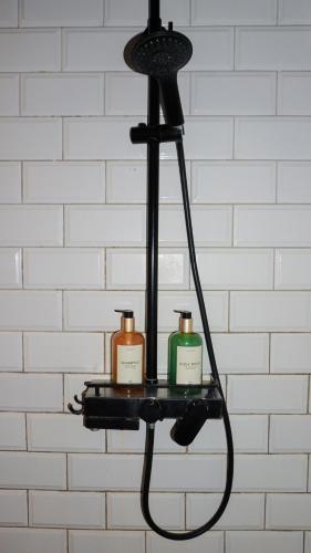a black chandelier with two soap bottles on a shelf at Happiness Villas in El Nido