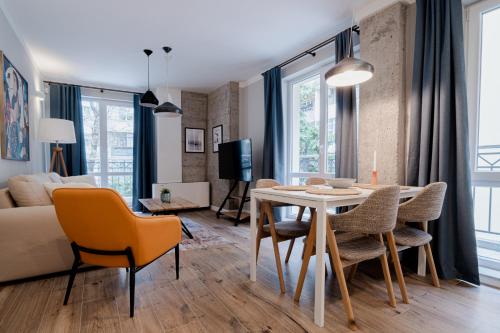 a living room and dining room with a table and chairs at 8th Hill Apartments in Plovdiv