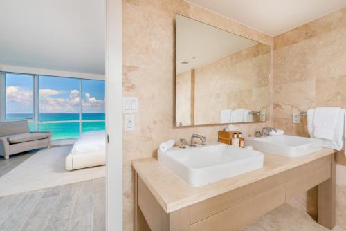 a bathroom with a sink and a mirror at Oceanfront Private Condo at 1 Hotel & Homes -1019 in Miami Beach