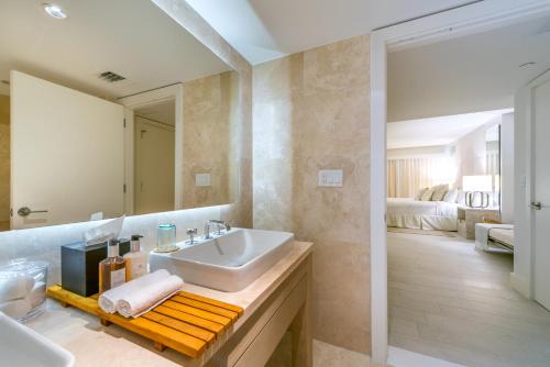 a bathroom with a sink and a mirror at Luxurious Private Condo at 1 Hotel & Homes -1445 in Miami Beach