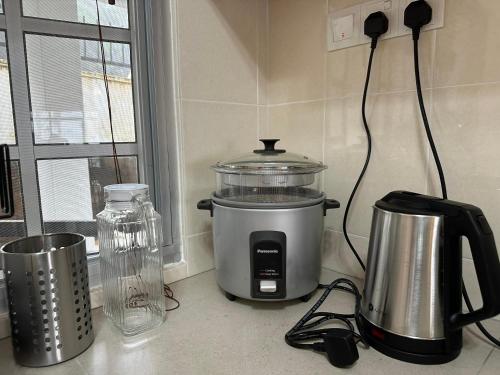 a kitchen counter with a food processor and a blender at Little England B9 in Bukit Fraser