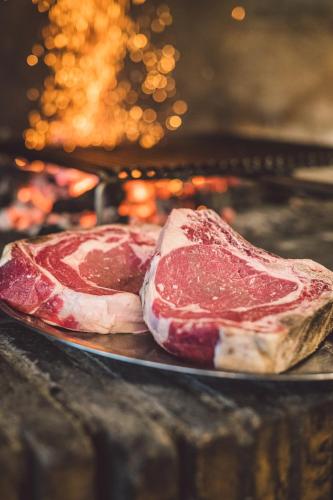 two pieces of meat on a plate in an oven at Due Ponti Village in Cesenatico
