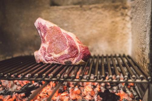 a piece of meat cooking on a grill at Due Ponti Village in Cesenatico