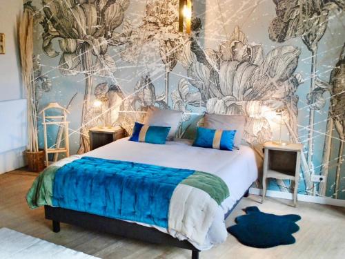 Un dormitorio con una cama y una pared con plantas. en La vie de chateau, en Grignan