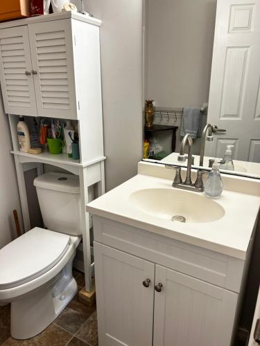 a bathroom with a white sink and a toilet at Comfortable room B in Kitchener