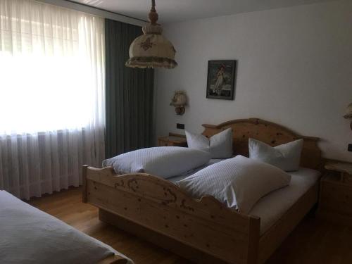 a bedroom with two beds and a large window at Haus Gerlinde Schernthaner in Langkampfen