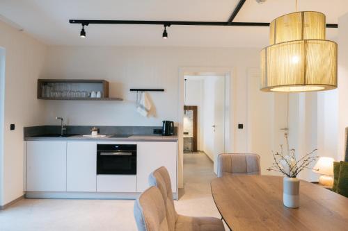 a kitchen and dining room with a wooden table at Boutique Apart Serfaus in Serfaus