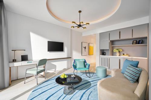 a living room with a couch and two chairs at voco Ma Belle Danang by IHG in Da Nang