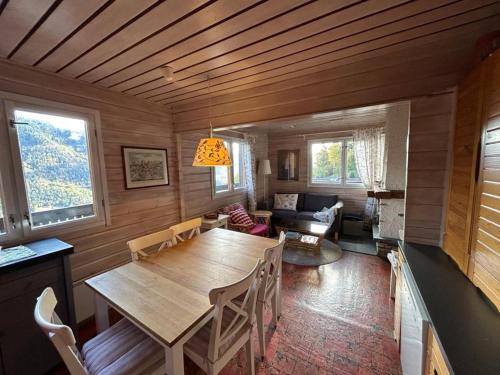 a living room with a table and a couch at Porkka COSY & QUIET chalet 8 pers in Vex