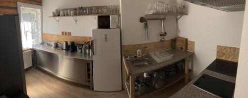 a kitchen with a sink and a refrigerator at Chalupa Anička in Pec pod Sněžkou