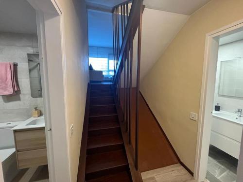 a staircase leading to a bathroom with a sink at Apartamento Masella pie de pistas. Ideal familias in Alp