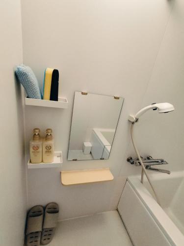 a bathroom with a mirror next to a sink at Hostel Belle Via Tokyo in Tokyo