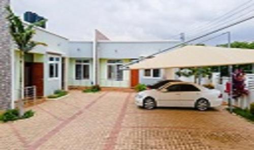 a white car parked in front of a house at Hamasa Apartments in Dodoma