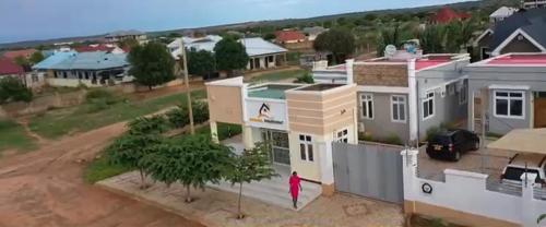 a person standing in front of a house at Hamasa Apartments in Dodoma