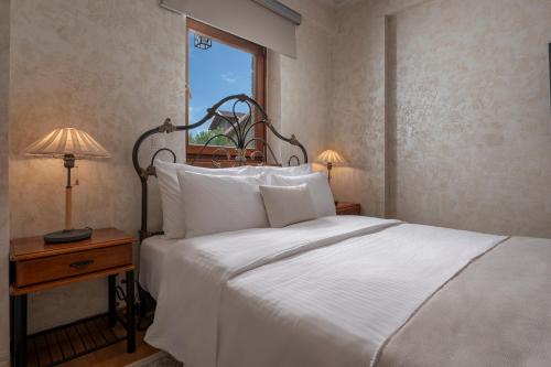 a bedroom with a white bed and a window at ViP Chalet 4 Seasons in Arachova