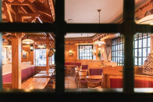 a view of a dining room with tables and chairs at Hôtel Le Bois Joli in Cauterets