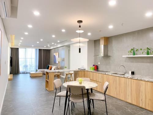 a kitchen and living room with a table and chairs at TSQ STAY Hotel Apartment in Hanoi