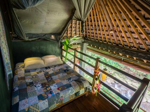 a bed in the middle of a room in a house at Bali Eco Stay in Blimbing