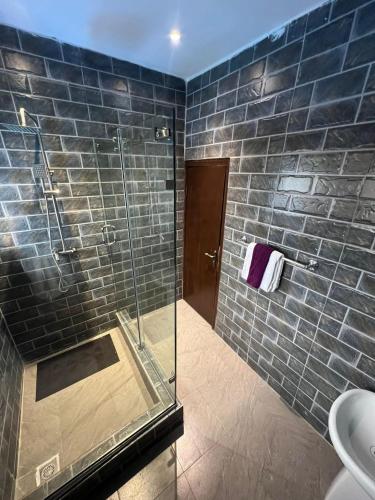 a bathroom with a glass shower and a toilet at Luxury 2 Bedroom family Apartment in Yaba Lagos in Lagos