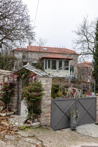 a house with a gate in front of it at Studio Penelope in Kerasochórion