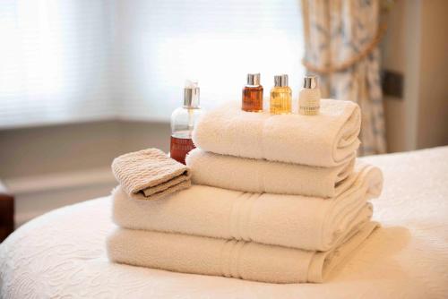 a stack of towels sitting on top of a table at Yorke Lodge Bed and Breakfast in Canterbury