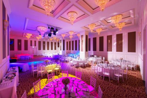 a banquet hall with white tables and purple lighting at Uranus Istanbul Topkapi in Istanbul
