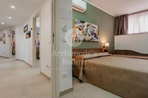 Кровать или кровати в номере Archimede's Rooms