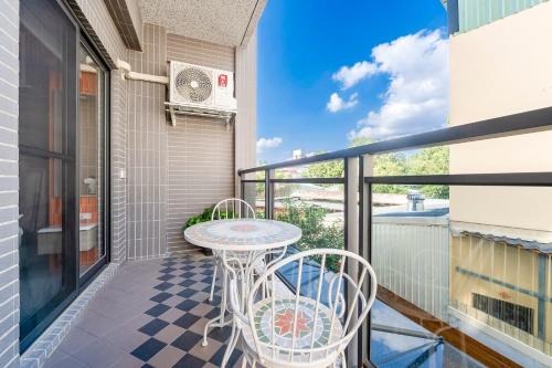 a patio with a table and chairs on a balcony at Yongyue 18 Homestay in Puli