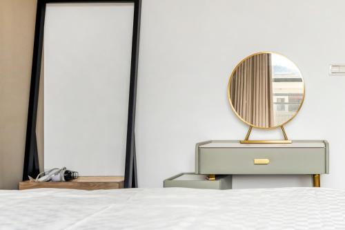 a bedroom with a dresser with a mirror on it at Yongyue 18 Homestay in Puli