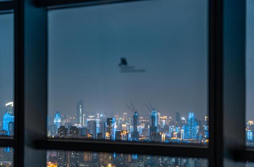 a view of a city skyline from a window at Wuhan Marriott Hotel Wuchang in Wuhan