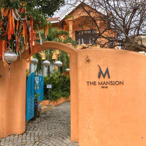 an entrance to the mansion with a sign on it at The Mansion Hoi An by Minova in Hoi An