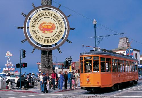 an orange trolley on a street with a sign at Fancy SF Suite, Prime Location, Near Fishermans Wharf, SF Bay and Financial District in San Francisco