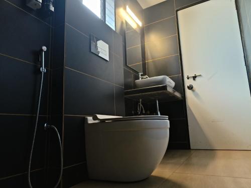 a bathroom with a toilet and a sink at Balaji Inn Guest House, Panjim in Panaji