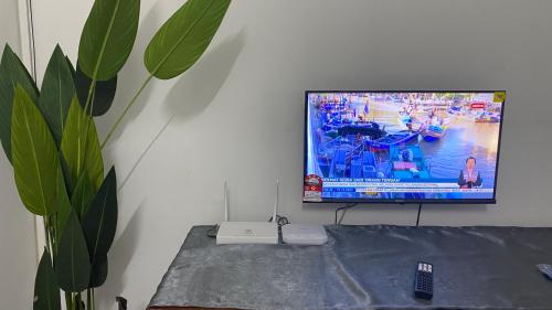 a flat screen tv sitting on top of a table at Homestay Dyzas in Batu Caves