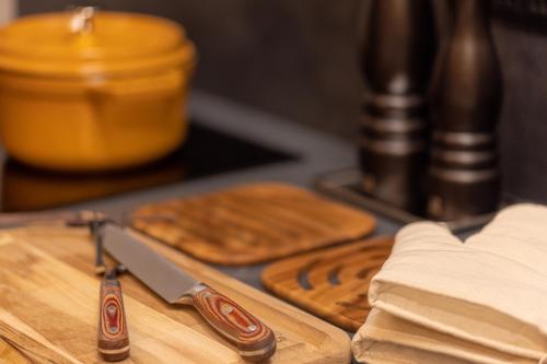 a knife sitting on top of a wooden cutting board at amane in Kyonan