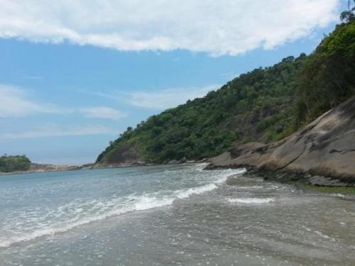 a view of a beach next to a mountain at Pousada Acqua Bella PISCINA CLIMATIZADA in Bertioga