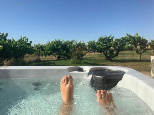 a person with their feet in a bath tub at Starry Night Farmstay in Forbes