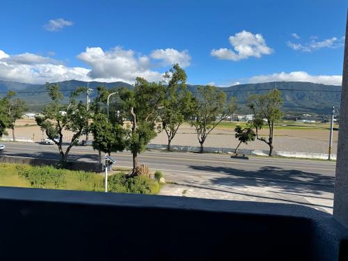 a view from a window of a street with trees at 玟均民宿 Wenjun 台東縣民宿1277號 in Chishang