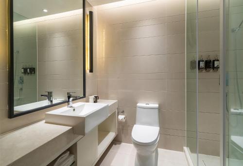 a bathroom with a sink and a toilet and a shower at SSAW Boutique Hotel Shanghai Bund in Shanghai