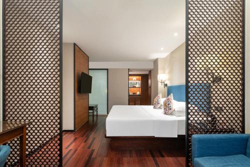 a hotel room with a bed and a tv at SSAW Boutique Hotel Shanghai Bund in Shanghai