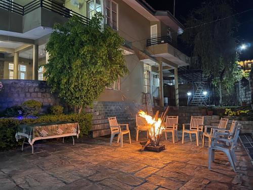 a fire pit in a patio at night at The Sojourn in Dharamshala