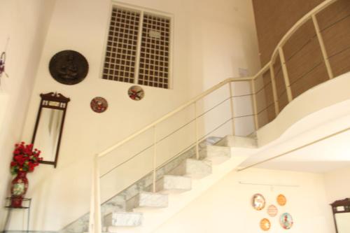 a staircase in a house with a window at The Sojourn in Dharamshala