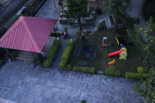 an aerial view of a miniature backyard with a pink house at The Sojourn in Dharamshala