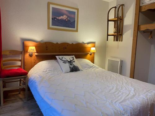 Un dormitorio con una cama grande con una almohada. en Chamrousse, pied d'une piste, terrasse vue sapins, en Chamrousse