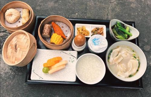 a tray filled with different types of food on a table at Jiangnan House Changyuan in Suzhou