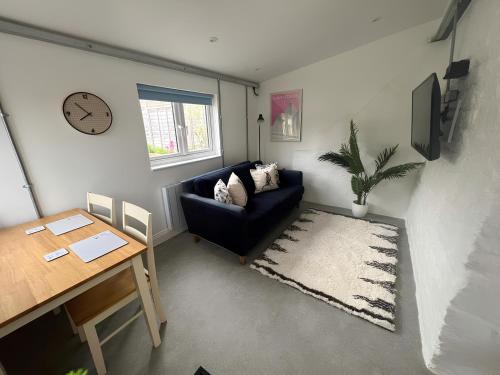 a living room with a couch and a table at The Dog House, Mere in Mere