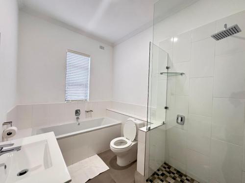 a bathroom with a toilet and a sink and a shower at Narina Villa in Victoria Falls